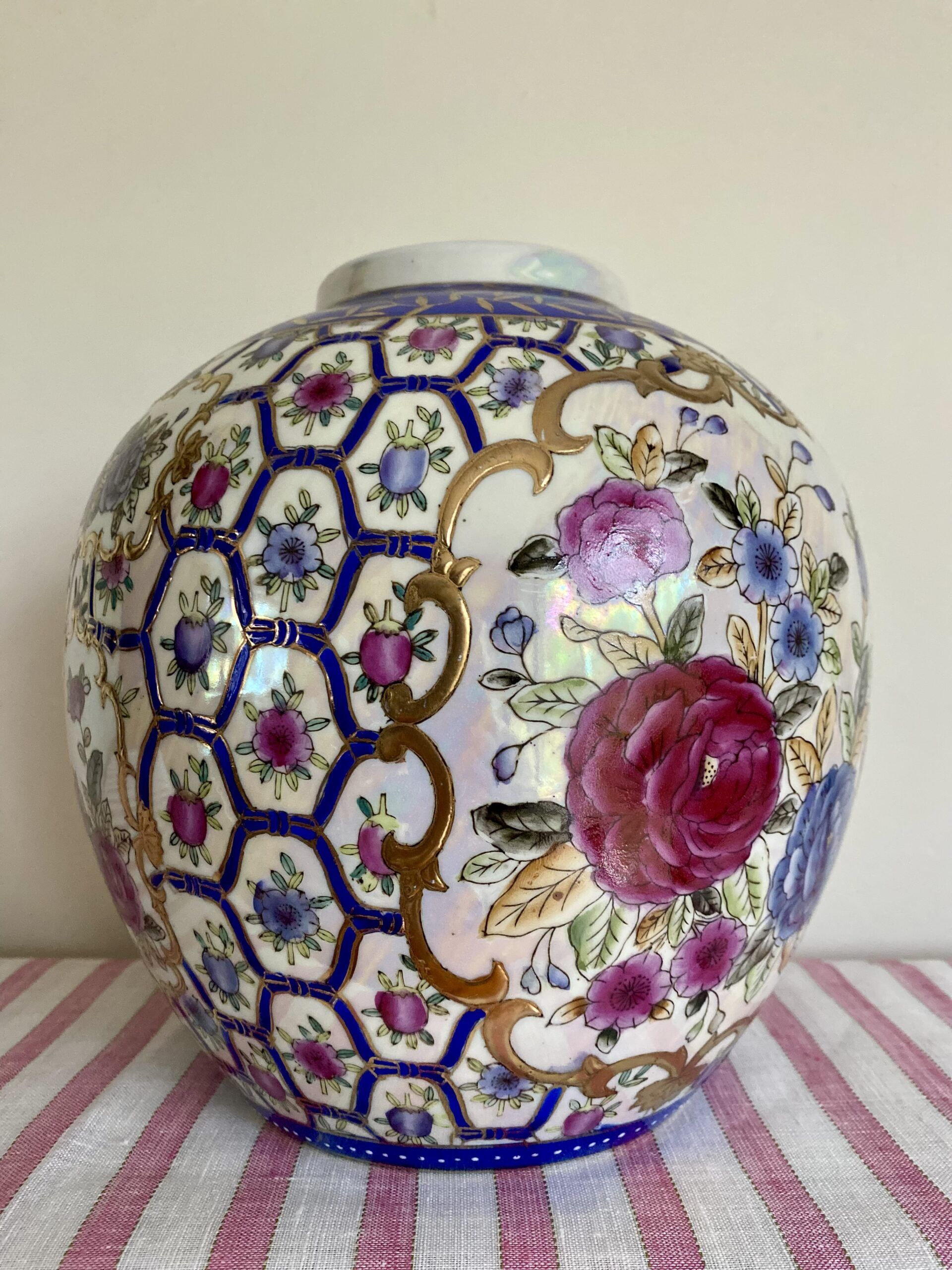 Vintage Chinese vase in pink with hand-painted rose design and florals with blue and gold-coloured accents.