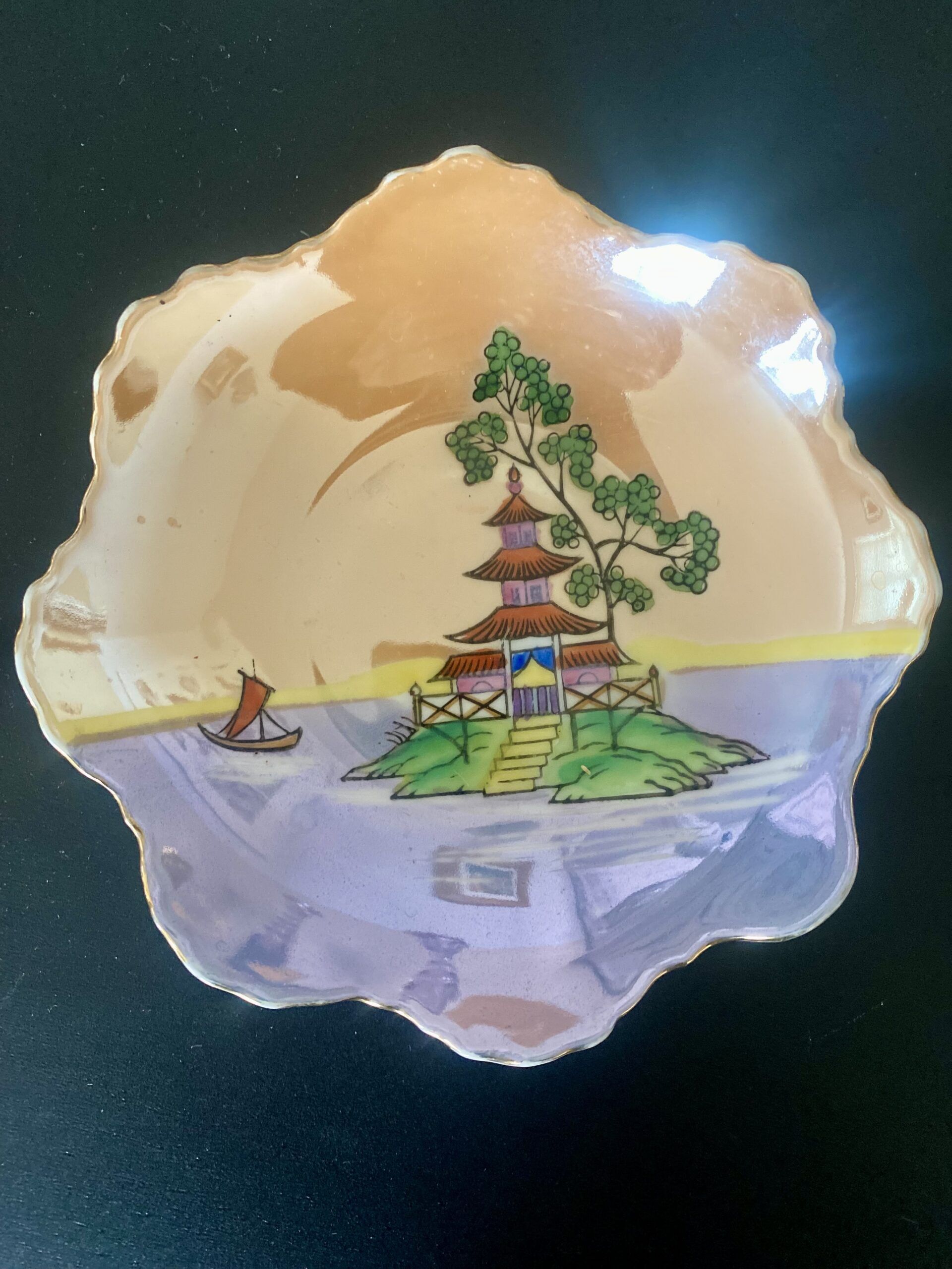 A vintage Japanese trinket dish with colourful lustreware finish.